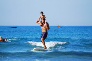 A busy father uses his limited time to do surfing as a fun sport in order to make the full use of time.