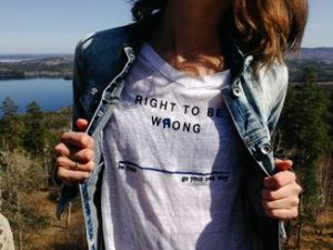 The girl is showing what is right and what is wrong by wearing a 'right and wrong' T-shirt. 